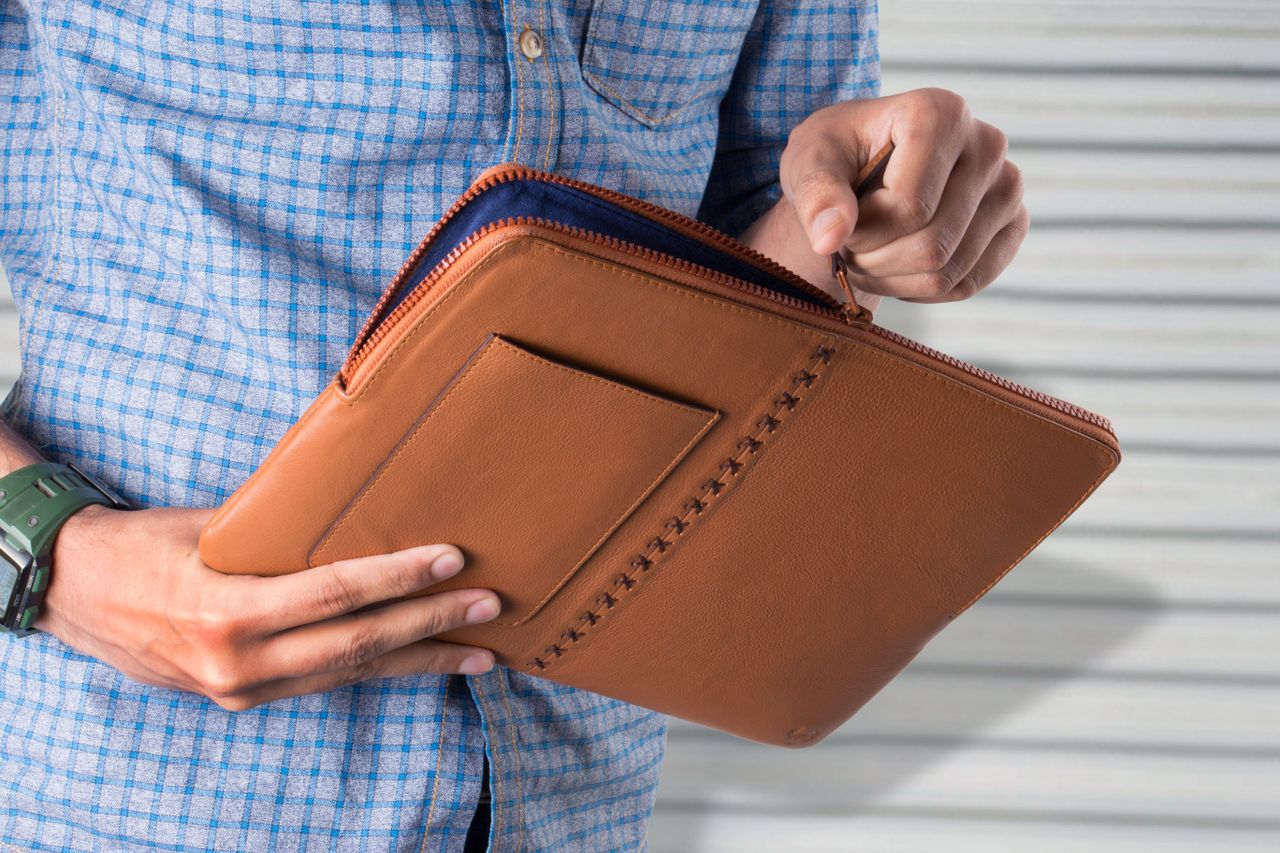 Mastering the First Impression: Your intriguing post title goes here Close-up of a man holding a stylish leather bag, perfect for fashion and lifestyle themes.